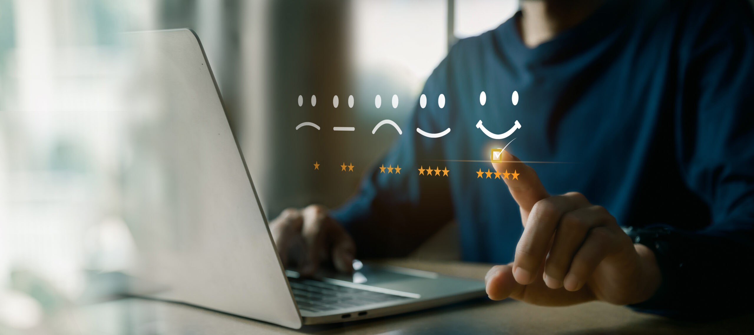 a person touching a laptop with smileys and stars representing employee experience